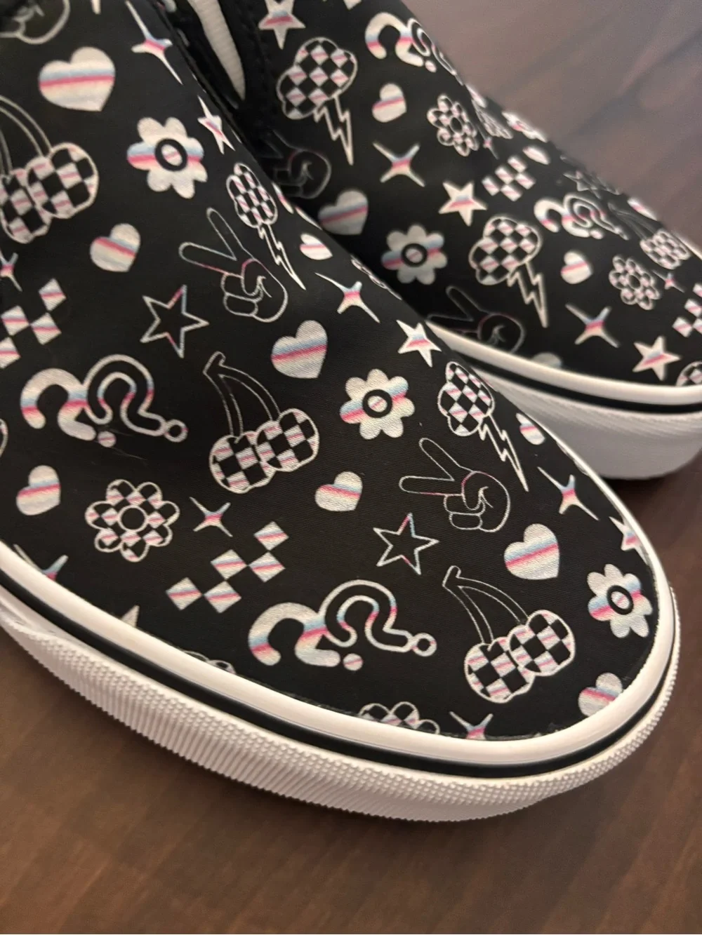 Vans Women’s Black Slip-On Sneakers with Multicolor Icon Accents